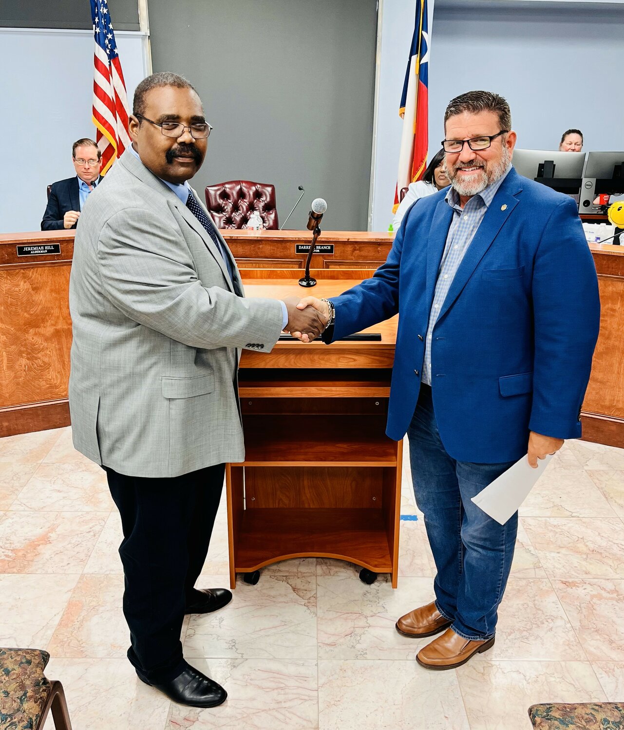 Brookshire Mayor Darrell Branch, left, shakes hands with Waller County Judge Trey Duhon May 11 at Brookshire City Hall after Branch took the oath of office for another term as mayor.
